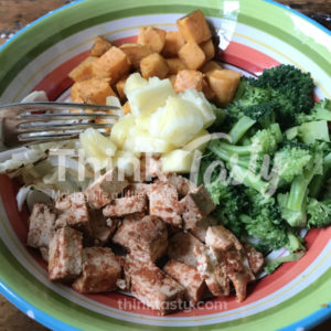 All sorts of flavors and textures in this bowl filled with season tofu, caramelized onions, roasted sweet potato and broccoli and topped with pineapple