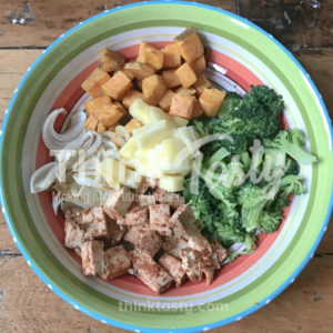 All sorts of flavors and textures in this bowl filled with season tofu, caramelized onions, roasted sweet potato and broccoli and topped with pineapple