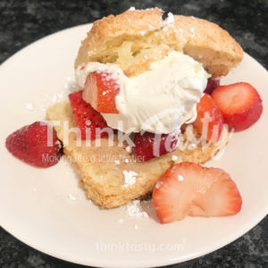 Homemade shortcake topped with macerated strawberries and mascarpone whipped cream
