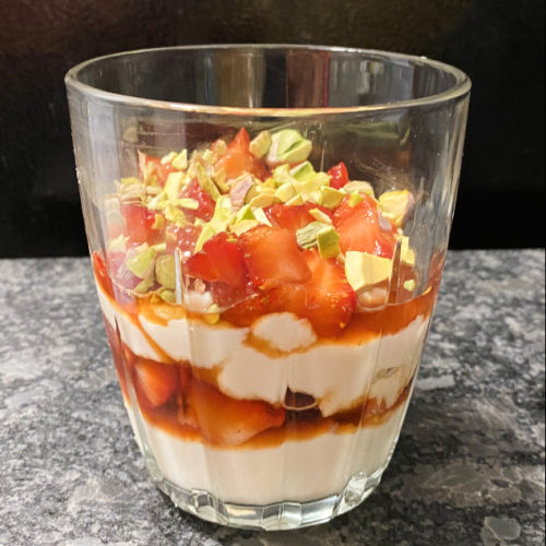layers of ricotta, strawberries, and pistachios