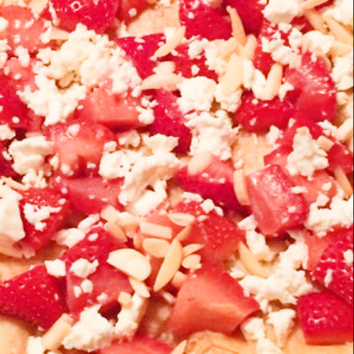 Pizza topped with strawberries and feta