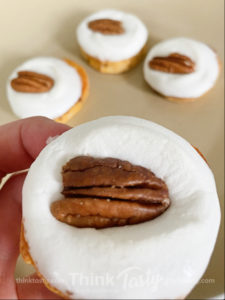 sweet potato round topped with marshmallow and pecan